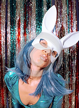 Disco Girl 80s in stylish holographic party look and rabbit mask. Tinsel installation. New year`s clubbing concept. Merry