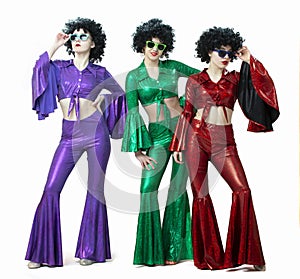 Disco style girls in colorful flared suits and African American wigs