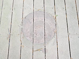 Discolored or worn or weathered wood deck boards with algae and circular shape