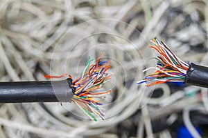 Disconnect. Breakdown of communication equipment. A damaged multi-core cable is shown close-up. Breakage of the telephone wire.