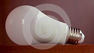 Disconnected electric energy saving light bulb in the room wardrobe sways