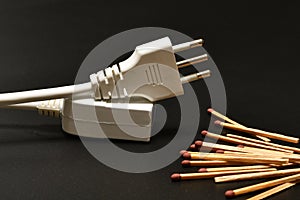 Disconnected electric power cords with matches. electricity supply problem concept. blackout. electricity supply problem concept.