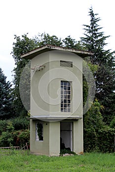 Disconnected old abandoned outdoor concrete electricity substation building without entrance doors and with broken windows