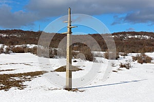 Disconnected old concrete electrical power line utility pole