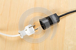 Disconnected white european power cable plug with black connector cable