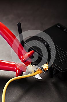 Disconnecting the Internet connection, cutting off the yellow Ethernet cable with wire cutters with a red handle on the Wi-Fi