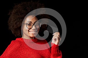 Discontent serious young African-American girl in glasses and red shirt