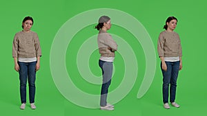 Discontent upset woman acting sad and discouraged posing over greenscreen