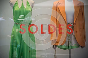 Discount sign SOLDES in french, the traduction of sales on window in french fashion store showroom