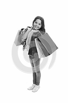 Discounts and promo codes. Girl carries shopping bags isolated on white background. Girl fond of shopping. Child cute