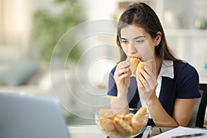 Discouraged anxious woman eating bakery