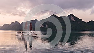 Discover Halong Bay Top Destinations Vietnam. Cruise Sails liner ship wooden junk sailing rock islands the emerald waters of Ha