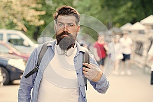Discover local showplace. Backpack for urban traveling. Hipster backpack urban street background. Bearded man travel