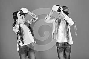 Discover virtual reality. Kids girls play virtual reality game. Friends interact in vr. Explore alternative reality