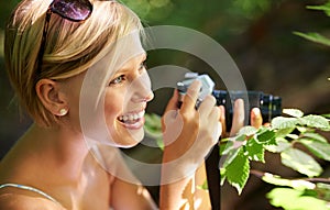 Discovery, photographer and nature with woman in forest for trees, environment and relax. Shooting, camera lens and