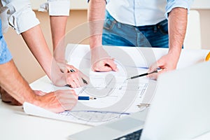 Discussion of construction plans in architects office