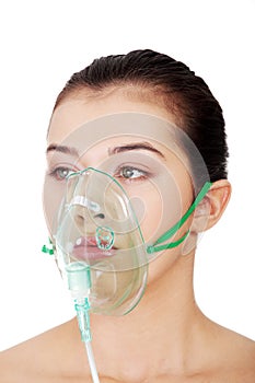 Diseased female patient wearing a oxygen mask