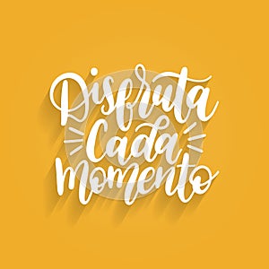 Disfruta Cada Momento translated from spanish Enjoy Every Moment vector handwritten phrase on yellow background. photo