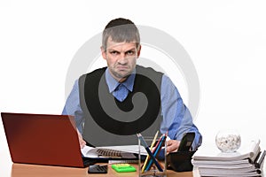 Disgruntled office worker sits in his workplace