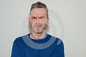 Disgruntled older man with puzzled expression photo