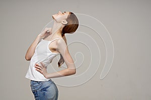 disgruntled woman back pain health problems osteoporosis light background
