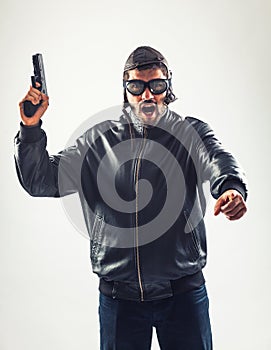 Disguised angry man holding a gun threatening photo