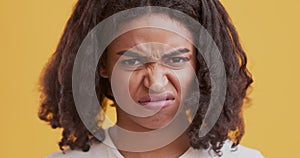 Disgusted black woman feeling aversion, frowning face