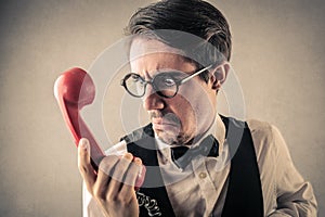 Disgusted businessman at the phone