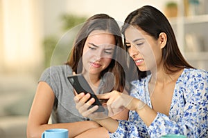 Disgusted friends watching media content on phone