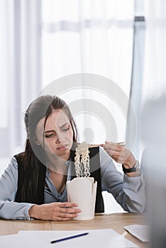 disgusted overworked manageress with box of junk take away noodles photo