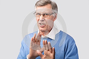 Disgusted Senior Man Gesturing No Posing On Gray Background, Studio