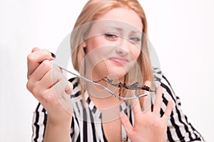 Disgusted woman eating insects with a fork in a restaurant