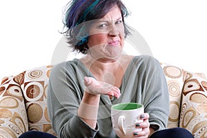 Disgusted woman gesturing to cup of tea