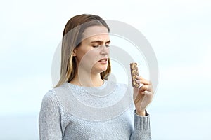 Disgusted woman looking to a snack bar on the beach
