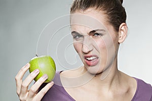 Disgusted woman unhappy with her apple