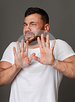 Disgusted young man feeling aversion towards something photo