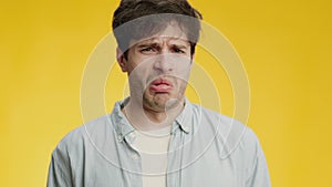 Disgusting air smell. Close up portrait of young man feeling awful aroma, frowning face and feeling gagging sensation