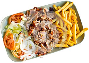 Dish with appetizing assorty of Armenian cuisine of delicious shish kebab, french fries, baked vegetables, tomatoes