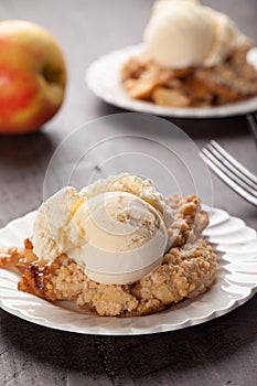 Dish of apple crisp with ice cream