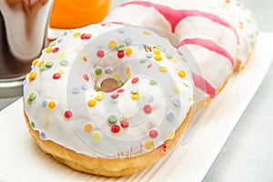 Dish with assorted donuts, coffee and juice