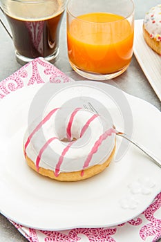 Dish with assorted donuts, coffee and juice