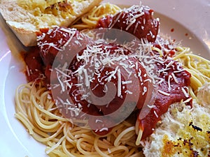 dish with beef balls in red tomato sauce, pasta and toast, traditional Italian food