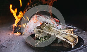 Dish of bone marrow roasted in a rustic wood-fired oven