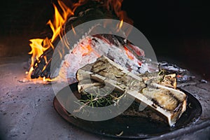 Dish of bone marrow roasted in a rustic wood-fired oven