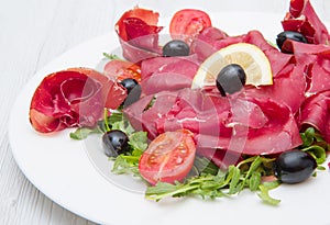 Dish of bresaola and aragula