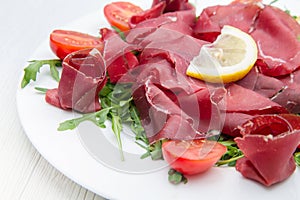 Dish of bresaola and aragula