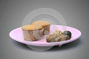 Dish with candy and cupcake