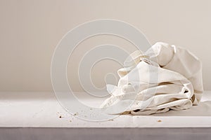 Dish cloth and crumbs on table photo