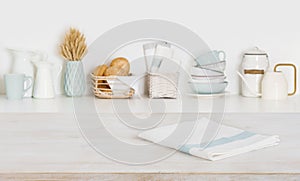 Dish cloth on wooden table over defocused kitchen counter background