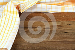 Dish cloth in yellow and white on brown wooden table